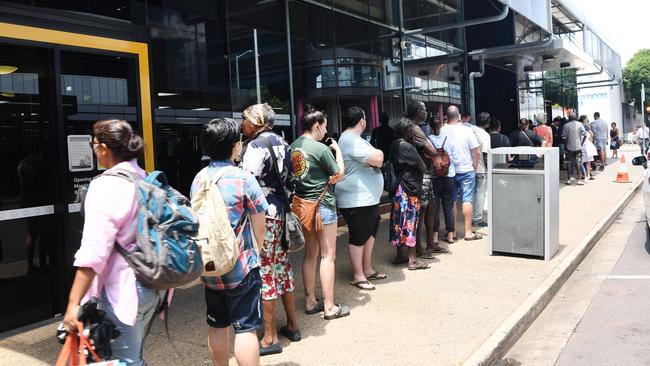 People lining up along the street at the Centrelink office on Knuckey St in the Darwin CBD. Picture: Katrina Bridgeford