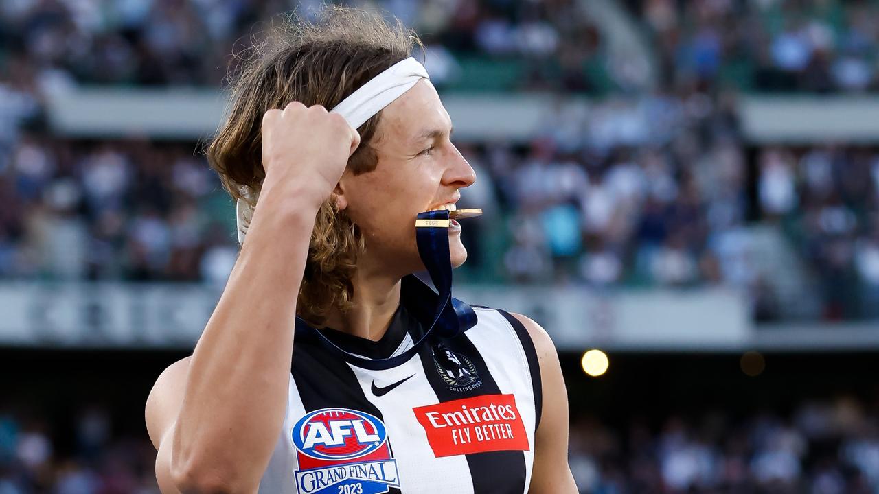 MELBOURNE, AUSTRALIA - SEPTEMBER 30: Jack Ginnivan of the Magpies celebrates after receiving his premiership medal during the 2023 AFL Grand Final match between the Collingwood Magpies and the Brisbane Lions at the Melbourne Cricket Ground on September 30, 2023 in Melbourne, Australia. (Photo by Dylan Burns/AFL Photos via Getty Images)