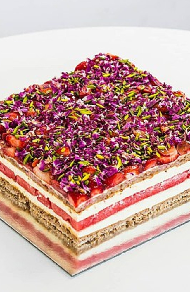 The original cake is layered with almond dacquoise, rose-scented cream and watermelon, and topped with strawberries, pistachios and dried rose petals. Picture: Black Star Pastry