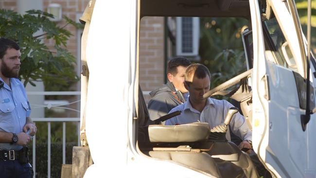 Police and detectives search the inside the cab of the truck that the man who fronted court was said to be driving.