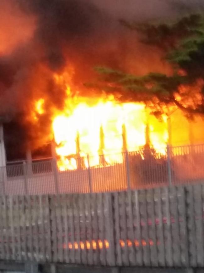 The intense Cosgrove High School blaze captured from a nearby resident's backyard at Glenorchy. Photographer: CHERYL GEEVES.