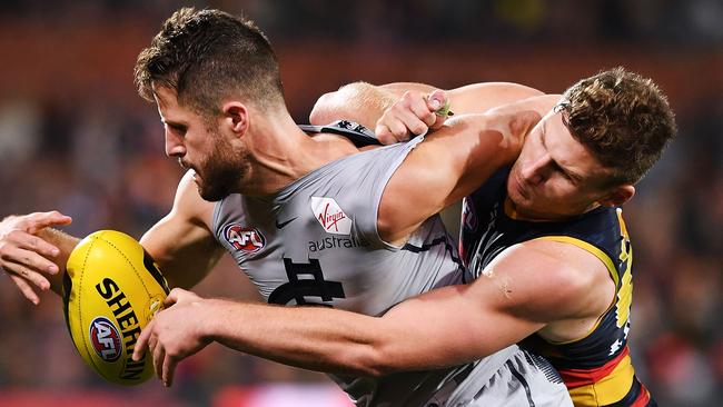 Crows star Rory Laird tackles former Crow turned Blue Matt Wright. Picture: Mark Brake/Getty Images