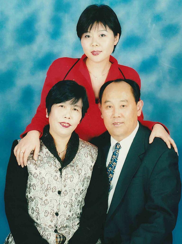 Whitney Duan (pictured with her parents) grew up poor but was determined to succeed.