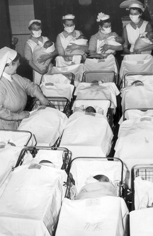 Babies and nursing staff at the Royal Women's Hospital in 1954. Babies were born and then whisked away to allow mothers to rest. Picture: HWt Library.