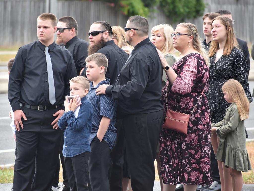 Friends and family watch as the hearse leaves the tabernacle.