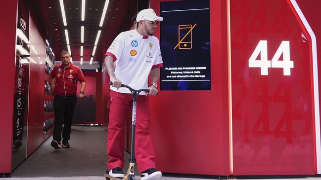 Lewis Hamilton regularly travels around pit lane on a scooter Picture: AP