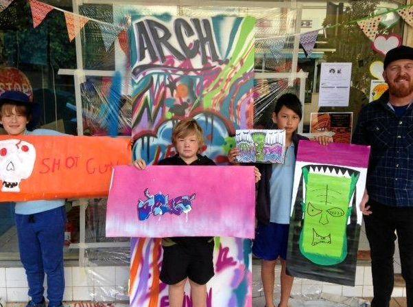 Finn, Levi and Padi create street art with artist Justin Livingstone at the ARCH community Arts Club on Carrington st in June.