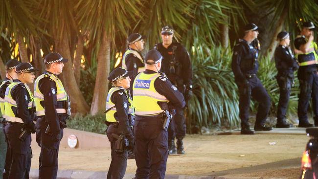 Police in St Kilda on Saturday night, watching as youths gather. Picture: Mark Stewart