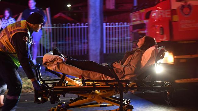 A woman is taken to hospital after collapsing at the scene last night. Picture: Gordon McComiskie