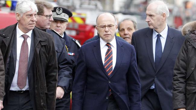 French Interior minister Bernard Cazeneuve (C) speaks to reporters after the raids. Picture: AFP.