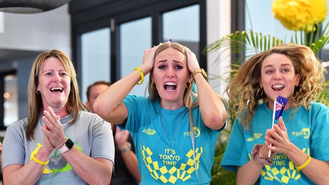 Sharron and Taylor McKeown and Tessa Wallace cheer on Kaylee McKeown as she wins gold in the 100m backstroke at the Tokyo Olympics. Picture Patrick Woods.