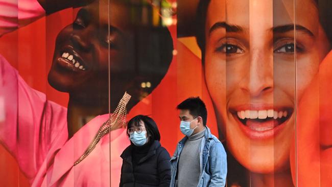 People wearing masks walk past a retail store in Sydney. GPT chief executive Bob Johnston said <span id="U71550138517DDC" style="font-family:'Times New Roman';font-size:12pt;">the tough rules to stop the pandemic have stalled the industry</span>. Picture: AFP