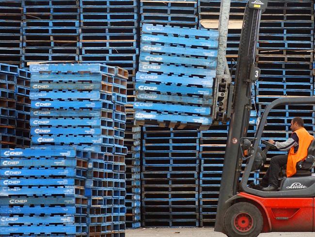 NOVEMBER 21, 2002: Forklift operator stacks empty wooden pallets at CHEP pallet depot in Sydney that is owned by Brambles Industries Ltd, 21/11/02 as investors hammered shares in group that are down more than 26. NSW / Industry