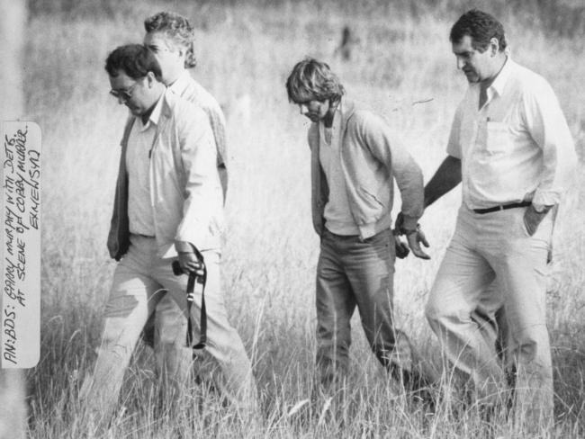 Gary Murphy with detectives in the paddock in western Sydney where the atrocities were perpetrated on nurse Anita Cobby in 1986.