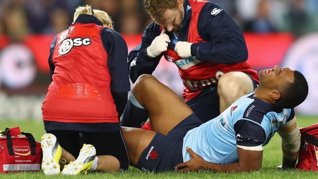 Kurtley Beale grimaces as he receives attention for an injury during in 2016.