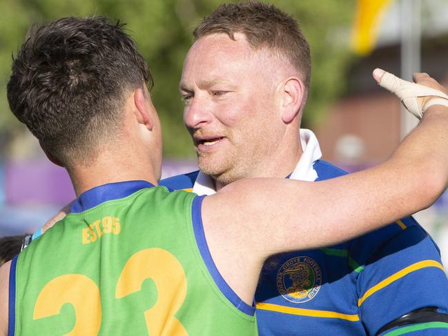 Golden Grove coach Eric Kells and player Brayden Shaw with team celebrate their win against Golden Grove. Adelaide Footy League division three Grand Final Golden Grove v Flinders Park at Norwood Oval. Photographer Emma Brasier