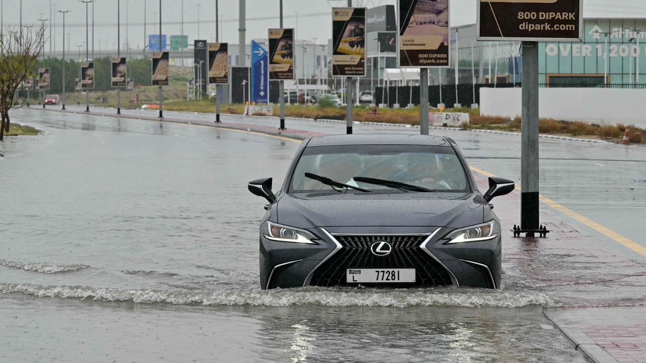 A car drives along a flooded street in Dubai on May 2, 2024, as heavy rains returned to the United Arab Emirates just two weeks after record downpours. Picture: Giuseppe Cacace / AFP