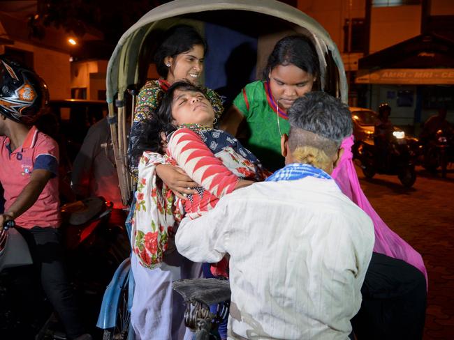 Powerful  ... Indian volunteers at Siliguri Hospital help a victim injured during an earthquake in Siliguri.  Picture:  AFP