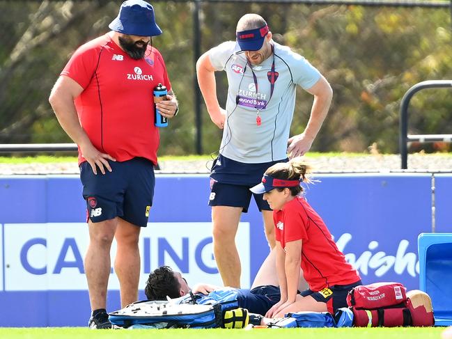 Demons head coach Simon Goodwin checks on Lever. (Photo by Quinn Rooney/Getty Images)