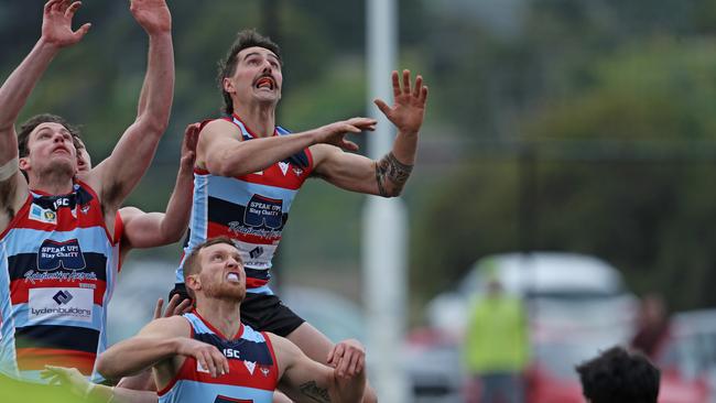 Lauderdale’s Robbie McManus, right, flies for a grab. Picture: LUKE BOWDEN