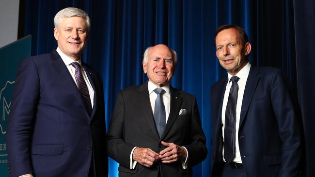 Former Canadian Prime Minister Stephen Harper with former Australian Prime Ministers Tony Abbott and John Howard in chat at the The Wesley Centre in Sydney. Picture: Hollie Adams/The Australian