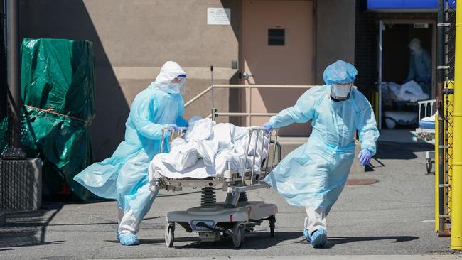 Bodies are moved to a refrigeration truck serving as a temporary morgue at Wyckoff Hospital in the New York borough of Brooklyn. Picture: AP