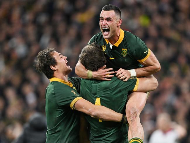 PARIS, FRANCE - OCTOBER 28: Jesse Kriel of South Africa celebrates with teammates Franco Mostert and Eben Etzebeth following the team's victory during the Rugby World Cup Final match between New Zealand and South Africa at Stade de France on October 28, 2023 in Paris, France. (Photo by Hannah Peters/Getty Images)