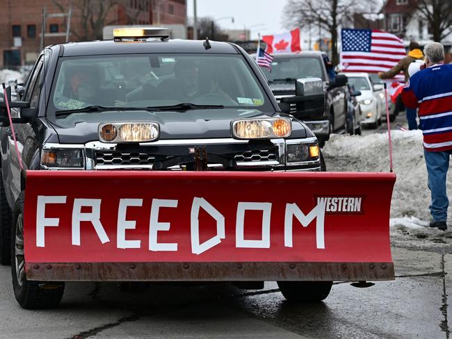 Protestors against Covid-19 vaccine mandates gather in solidarity with Canadian Truckers near the Niagara Peace Bridge in Buffalo, New York, on February 12, 2022. - Police in Canada were positioning Saturday to clear the bridge on the US border, snarled for days by truckers protesting against vaccination rules, an AFP journalist observed. "We urge all demonstrators to act lawfully & peacefully," police in Windsor, Ontario, home to the Ambassador Bridge, tweeted in announcing the deployment. (Photo by DUSTIN FRANZ / AFP)