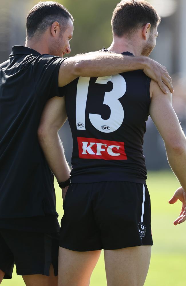 Taylor Adams speaks to a Magpies strength and conditioning staff member at training on Tuesday. Picture: Michael Klein