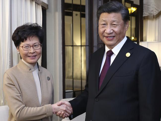 Chinese President Xi Jinping poses with Hong Kong Chief Executive Carrie Lam during a meeting in Shanghai, China. Picture: Ju Peng/Xinhua/AP