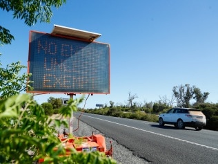 LAKE CLIFTON, AUSTRALIA - FEBRUARY 01:  Border control signs alert drivers from the south west on the way to Perth on February 01, 2021 in Lake Clifton, Australia. Lockdown restrictions are now in place across the Perth, Peel and South West regions of Western Australia following the discovery of a positive community COVID-19 case in a worker from a quarantine hotel facility.  As of 6pm on Sunday, people Perth, Peel and the South West are subject to stay at home orders, and will only be allowed to leave their homes to shop for essentials, for medical or health needs, exercise within their neighbourhood or travel to work if they cannot work from home. Face masks are now mandatory outdoors, with all restrictions to remain in place until 6pm on February 5. (Photo by James Worsfold/Getty Images)