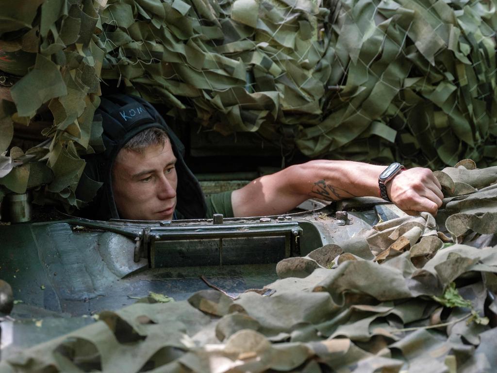 A Ukrainian serviceman of the 3rd Independent Tank Iron Brigade looks out of a tank hatch at a position near the front line in Kharkiv region, on June 15, 2023. Picture: AFP