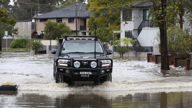 Homes on Knights Road in Lansvale have been flooded for a second time this week. A resident drove his car through the waters to reach his house. Picture: David Swift