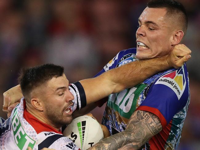 Roosters James Tedesco is tackled by Newcastle's David Klemmer and Newcastle's Mitchell Pearce during the Sydney Roosters v Newcastle Knights NRL match at McDonald Jones Stadium, Newcastle. Picture: Brett Costello