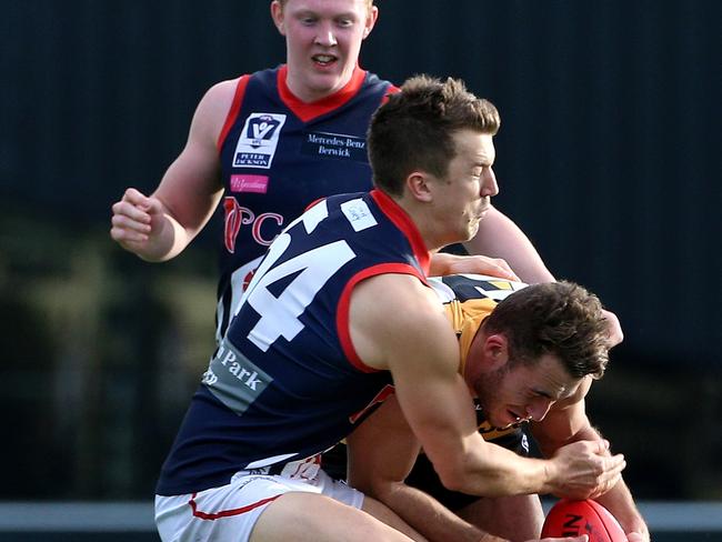 Jack Trengove of Casey lays a strong tackle in the VFL as Clayton Oliver arrives on the scene. Picture: Mark Dadswell