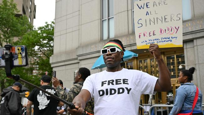 A Sean ‘Diddy’ Combs' fan holds a sign outside federal court. Picture: Angela Weiss / AFP