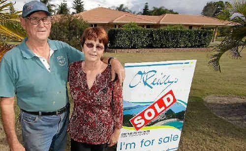 Joe and Lorraine Challacombe stand outside their newly bought home after moving in a week ago. Picture: CHRIS ISON