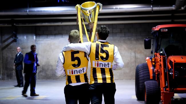 Sam Mitchell and Luke Hodge in the car park of the MCG with the 2014 AFL premiership Cup. 2014 AFL Grand Final match between Hawthorn Hawks and the Sydney Swans at the MCG Melbourne Cricket Ground on September 27, 2014. AFLGF2014 Picture: Nicole Garmston