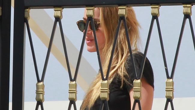 Amber Heard behind the balcony bars of her rooftop terrace at Palazzo Versace. Picture: Mike Batterham