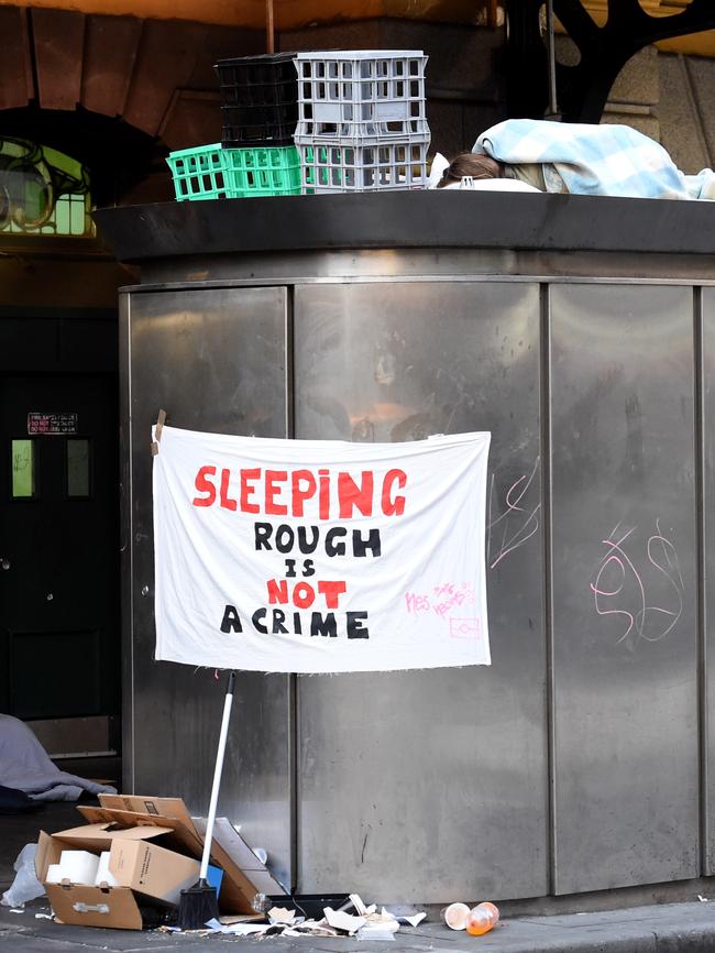 A man sleeps on the roof of a public toilet. Picture: Nicole Garmston