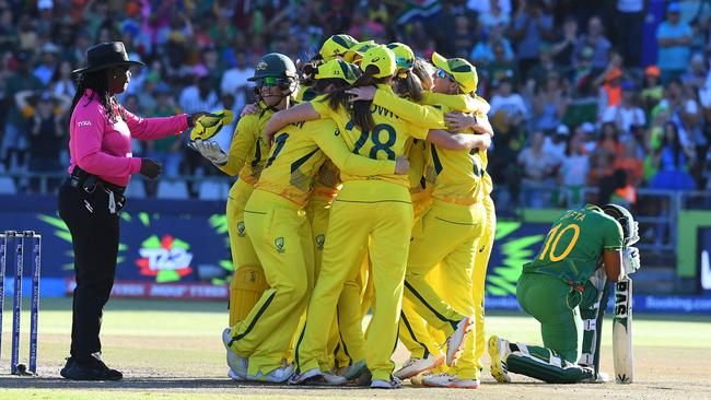 South Africa's Sinalo Jafta drops to her knee as Australian players celebrate winning the final of the 2023 T20 women’s World Cup in Cape Town. Picture: Rodger Bosch/AFP