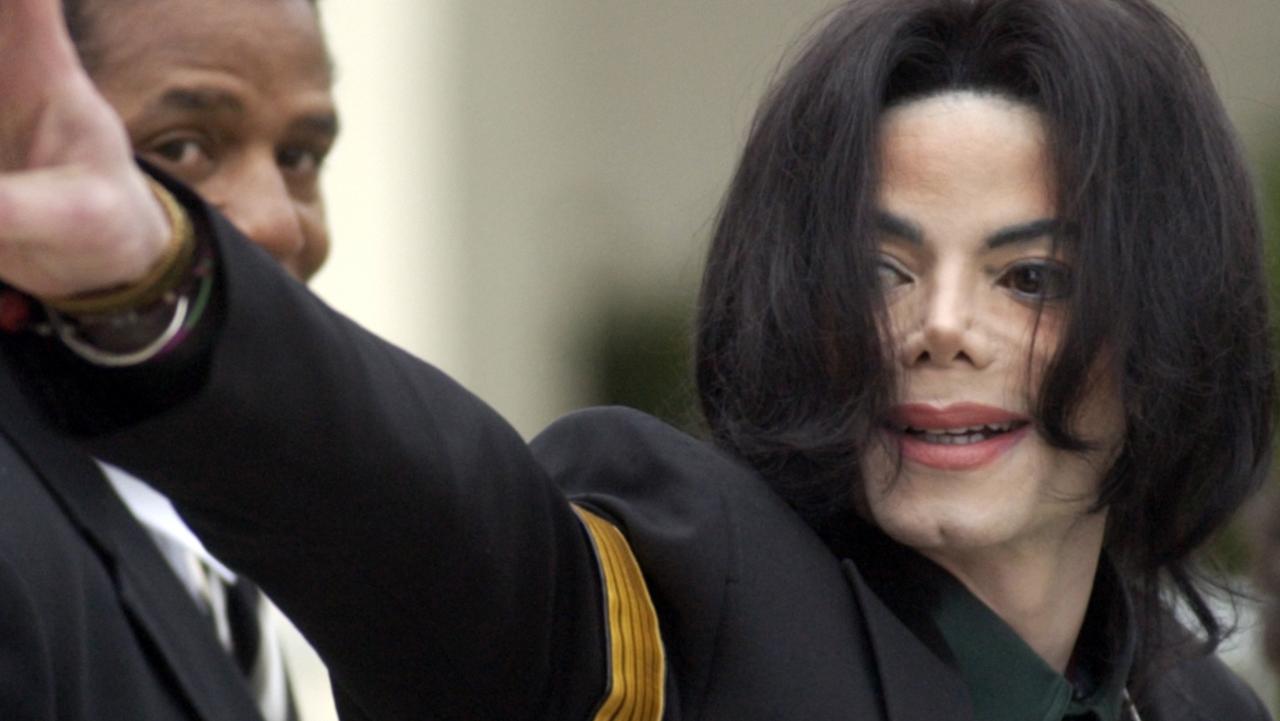 Michael Jackson waves to his supporters as he arrives for his child molestation trial in 2005.