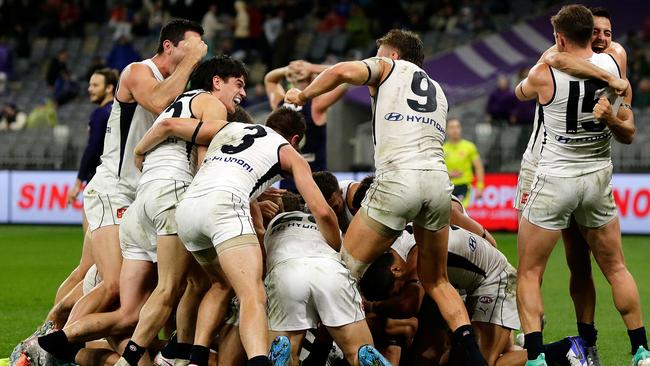 Carlton players celebrate the after-the-siren win. Picture: Getty