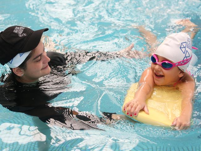 CANTERBURY BANKSTOWN EXPRESS/AAP. Roselands Leisure and Aquatic Centre's Learn to Swim Instructor Elleni Andeopoulos instructs Samara Sbeit (5) with swimming lessons at Roselands, 7th December 2019. Canterbury Bankstown wants to prevent drownings after 11 residents from Canterbury-Bankstown, all born overseas, drowned over a five-year period to 2018. (AAP IMAGE / Robert Pozo)