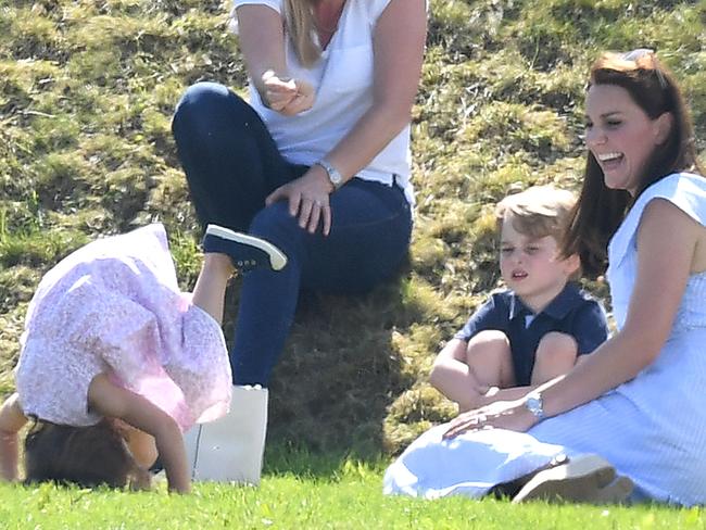 Princess Charlotte enjoys herself as Kate and George look on. Picture: Mega