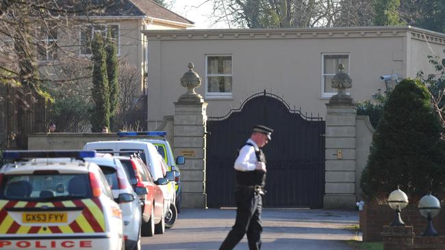 A British police officer patrols outside Downside Manor in England in February, after Georgian tycoon Badri Patarkatsishvili was found dead there.