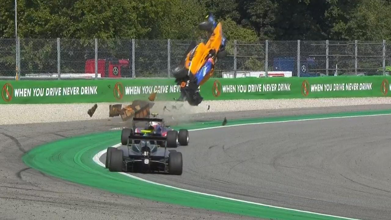 Peroni's car launches off the Parabolica sausage kerb.