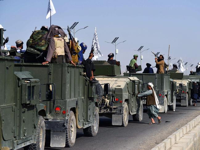 Taliban fighters atop Humvee vehicles before parading along a road in Kandahar to celebrate after the US pulled all its troops out of Afghanistan. Picture: JAVED TANVEER / AFP.