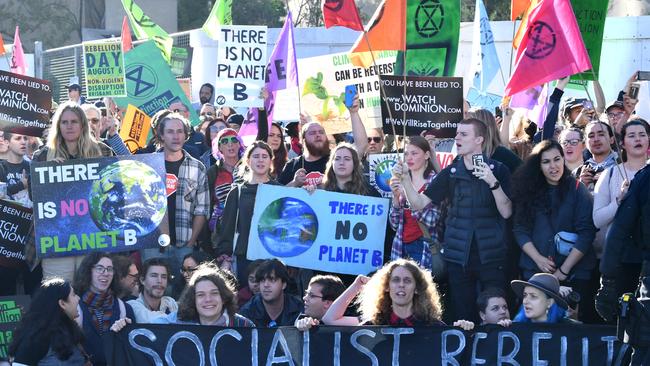 Extinction Rebellion protesters blocking the corner of Margaret and William streets in Brisbane’s CBD yesterday. Picture: Darren England/AAP