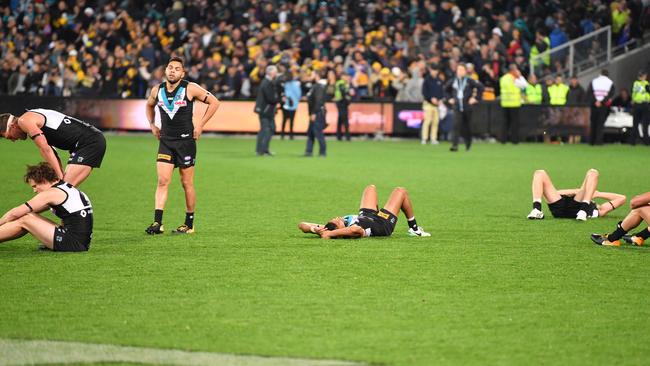 Dejected Port players after the siren. Photo: AAP Image/David Mariuz